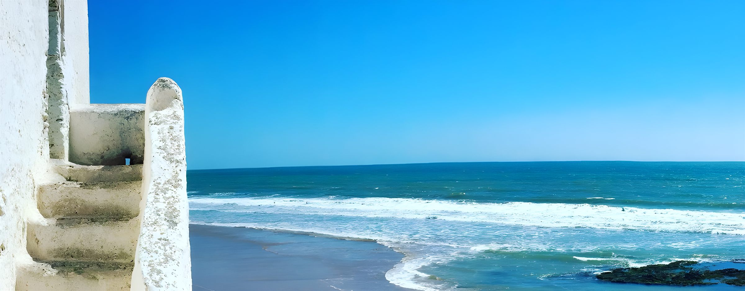 White coastal stairs opening onto the Atlantic ocean
